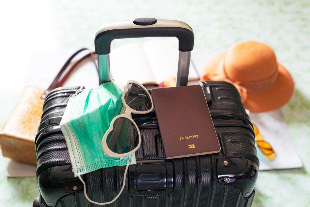 Luggage and travelSuitcase passport and medical maskFlights canceled or delayed transportation