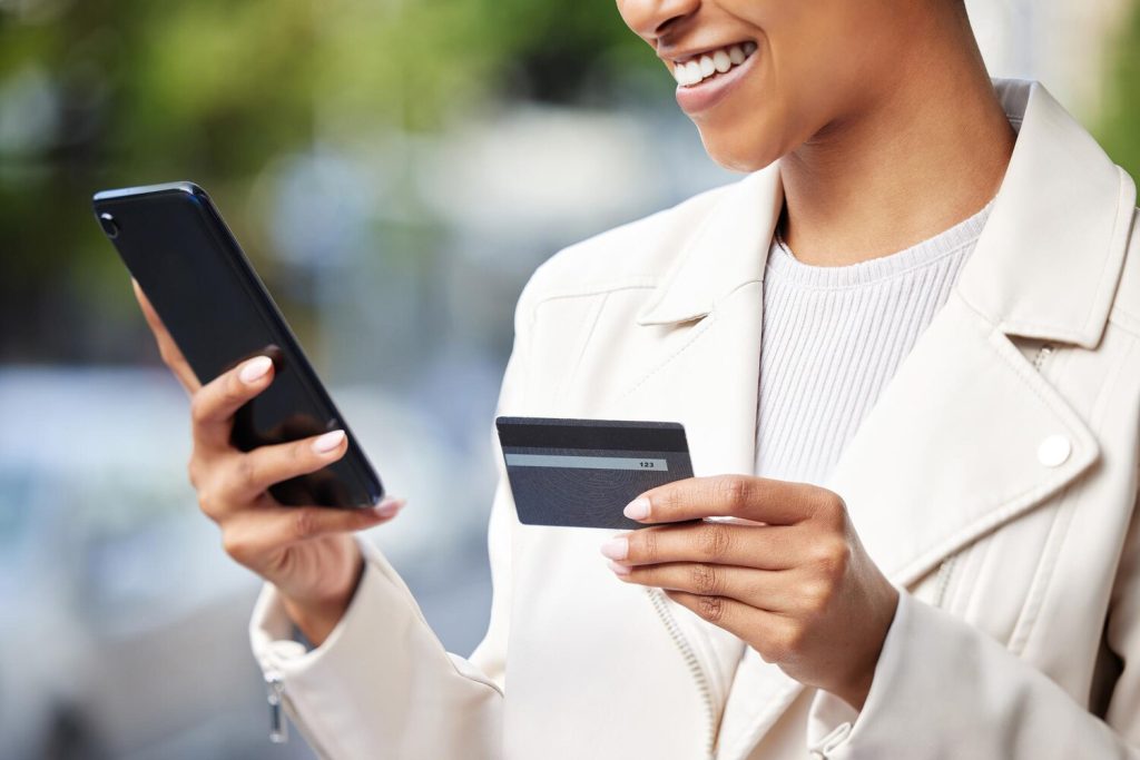 Fintech business woman with phone online shopping ecommerce and credit card doing financial payment or banking Corporate finance hands using a 5g network and safe digital bank app or software