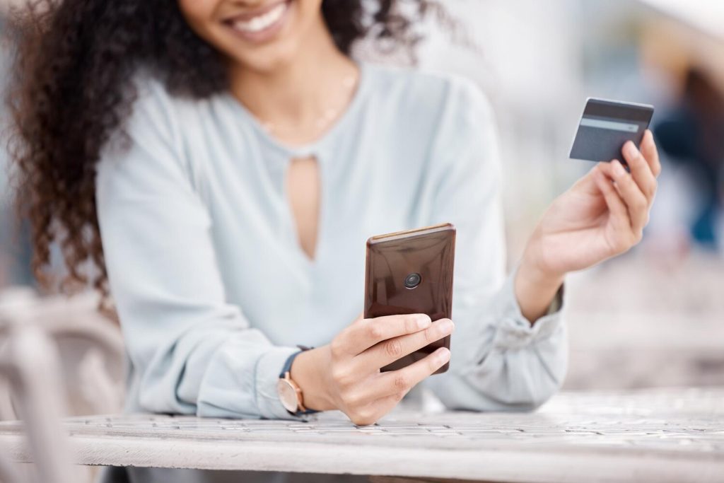 Ecommerce credit card and woman online shopping on smartphone for digital payment website Happy customer typing security bank information on safe e commerce banking or fintech software application