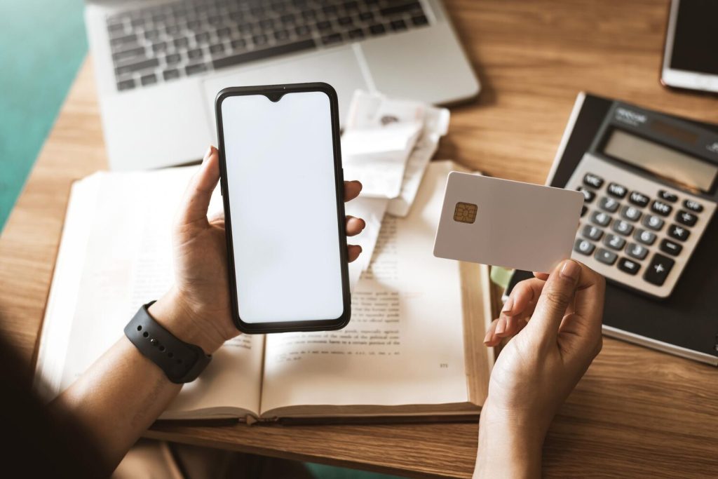 Woman using mobile smartphone and credit card at home Shopping Online